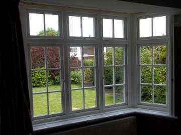 NORTHWICH CHESHIRE - Internal view of an Installtion of Evolution "STORM 2 " white wood PvcU Bay window , complete with Astragal bar glass design and dummy sash look to give the glass the same size panes. 